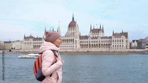 Admire parliament building in budapest. A smart woman traveler admire the Budapest parliament place by the water during holiday time