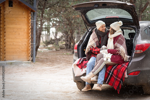 Young couple with plaid sit...