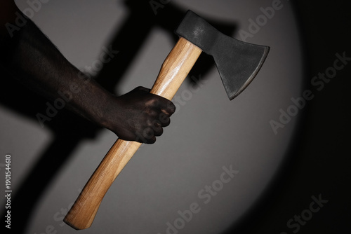 Hand in black paint holding...