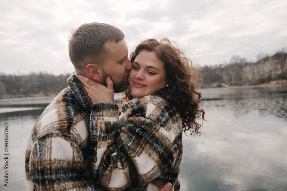 Fototapeta premium Couple shares a romantic moment by the water on Valentines Day while enjoying their connection and love