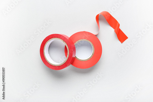 Red adhesive tape rolls on ...