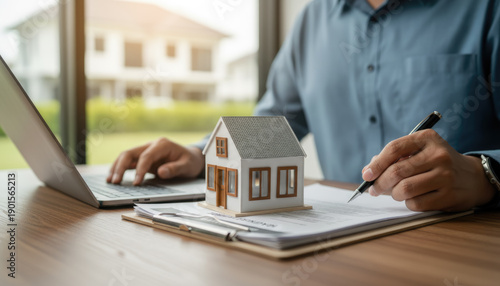 Wallpaper Mural Real Estate Agent Signing Home Purchase Contract with Laptop and House Model Torontodigital.ca