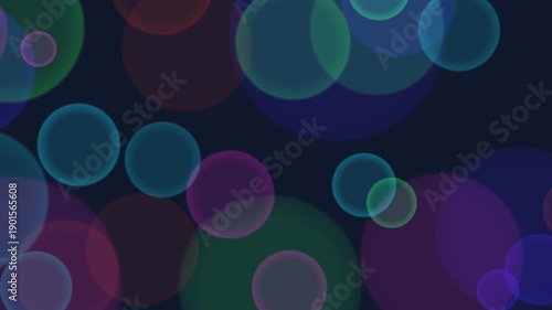 Seamless loop of floating translucent multicolored circles or bubbles against a dark background. This abstract bokeh animation is perfect for intros, overlays, parties, music videos, and others