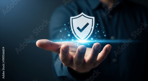 A person's open hand holds a glowing shield with a checkmark, symbolizing security and protection in a digital or abstract context.