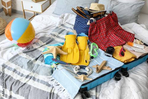 Open suitcase with men's sw...