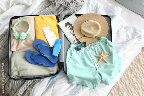 Open suitcase with men's sw...
