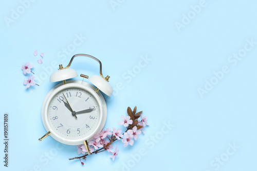 Alarm clock and flowers on ...