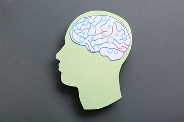 Paper human head with brain on dark grey background. World Mental Health Day