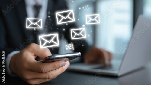 a businessman using his smartphone to check an email, with glowing white envelope icons floating above the screen background is blurred and shows part of their office desk with a laptop Generative AI