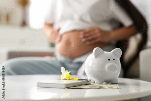 Piggy bank with baby pacifi...