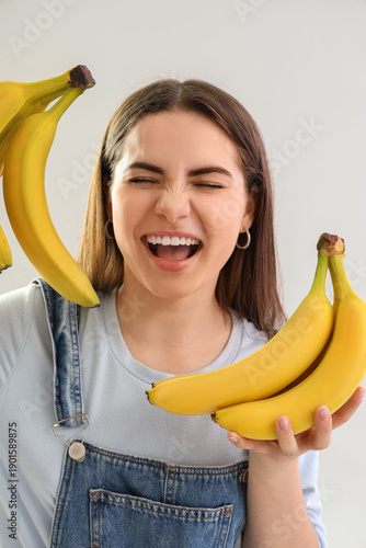 Happy young woman with bana...