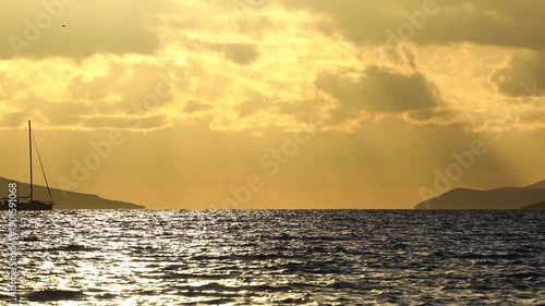 Sailboat at sea. Seascape golden sunrise over the sea. Yacht sailing in the sunrise time. Sea landscape view with a beautiful sailboat. Yachting tourism sea voyage on the sail boat