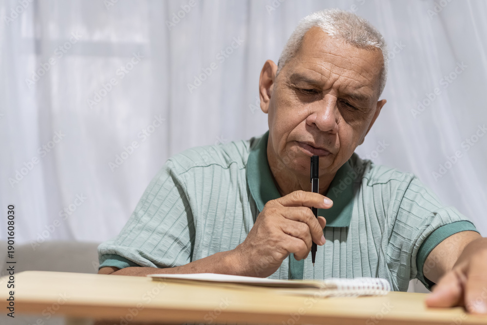 Naklejka premium Routines senior man thinking, contemplating, and writing ideas at home
