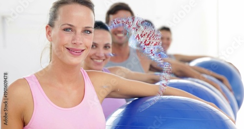 Tableau sur toile Smiling woman in pink tank top standing in fitness studio, resting arm on blue e