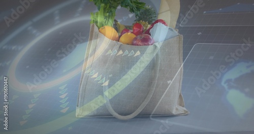 Showing beige canvas tote holding greens, baguette, fruit, carton on gray table, HUD overlays