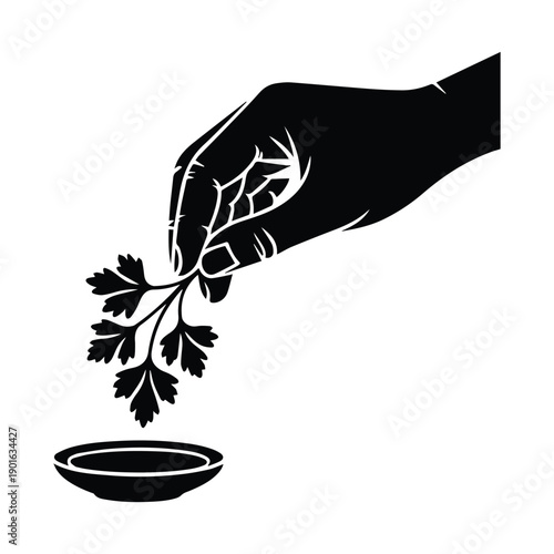 Hand holding parsley over bowl for fresh culinary delight