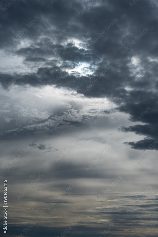 Obraz premium Stormy winter weather sky with patterns of dark and light clouds, as a moody nature background 