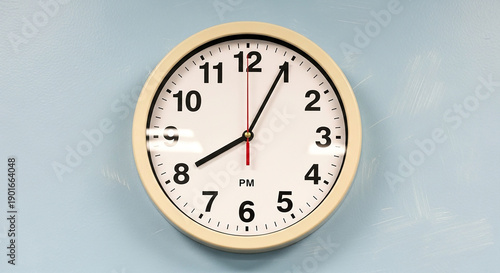 White round wall clock showing 1015 P M on light blue background round clock white clock