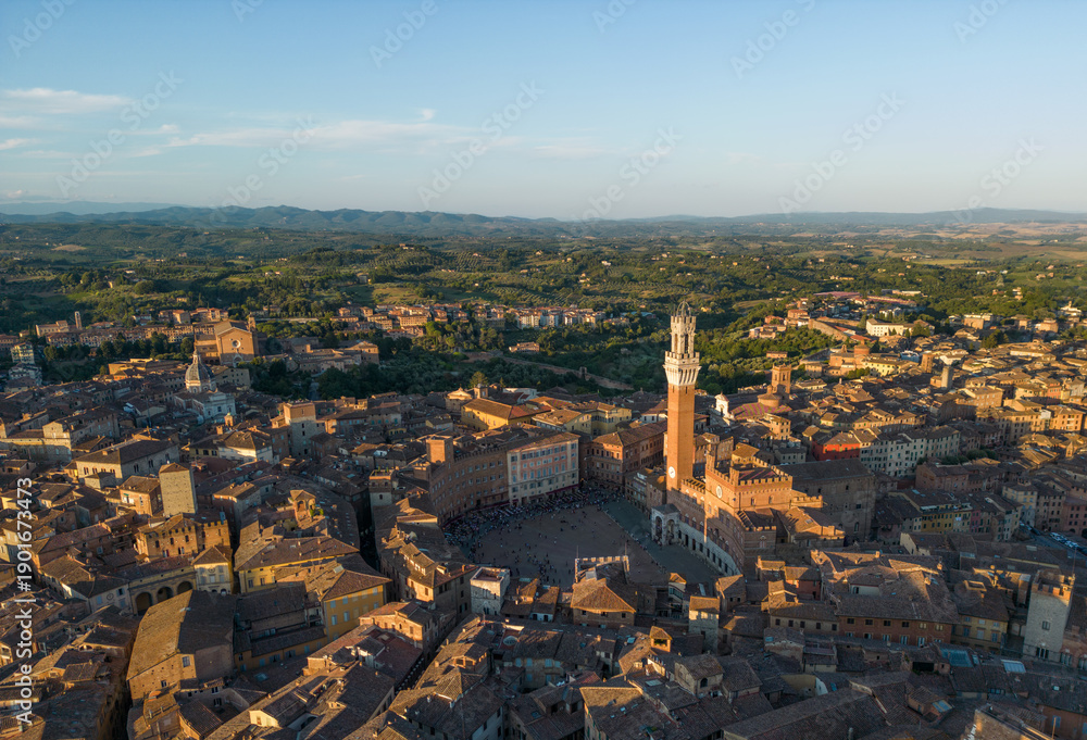 Fototapeta premium Aerial view of Siena Piazza del Campo featuring Torre del Mangia surrounded by medieval buildings in Tuscany, Italy