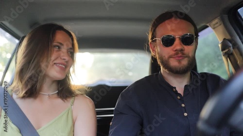 a young couple is traveling by car