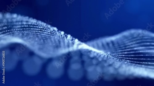 blue wave of glowing dots on dark background