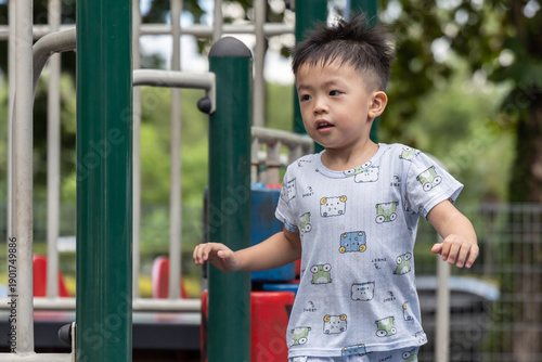Happy asian boy smiling and playing in playground