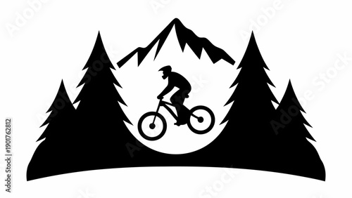 Mountain biker riding through forest landscape silhouette