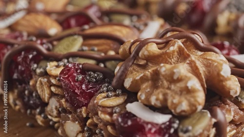 Wallpaper Mural Macro view of a chocolate-drizzled bar packed with nuts, seeds, and dried fruit Torontodigital.ca
