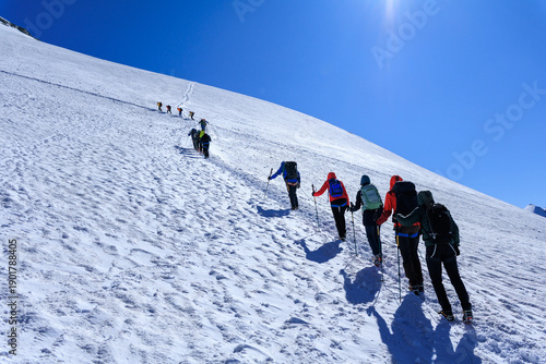 Schilderij op canvas Four rope teams with crampons ascending towards mountain Breithorn on glacier in