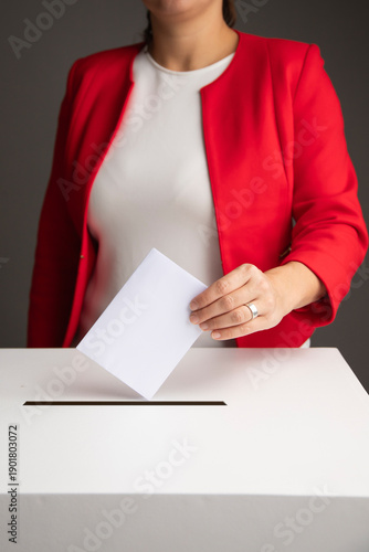 The voter holds his vote ballot paper and places it in the ballot box. Election concept.