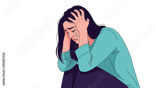 Young woman in despair sitting on the floor and crying with her hands on her head against a plain white background.