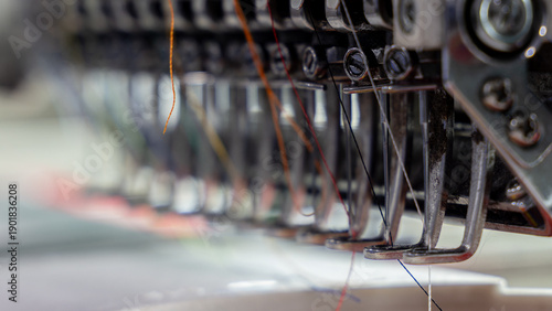 Extreme close-up of Embroidery machine needle in Textile Industry at Garment Manufacturers, Embroidery needle, Needle with thread