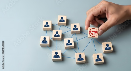 A hand connects wooden blocks with silhouette people icons illustrating networking recruitment or team building on transparent background high quality professional