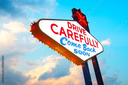 Drive Carefully Come Back Soon Sign, Welcome to Fabulous Las Vegas Sign. Logo Removed. The beautiful sunset sky in the background.
