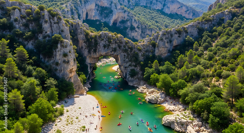 Aerial shot of Gorges de l'Ardèche limestone canyon natural arch and river canoeing