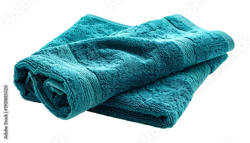A folded teal bath towel with soft texture isolated on a black background