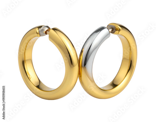 Pair of gold and silver earrings on black background