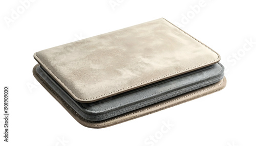 Stacked, rectangular leather cases in neutral tones on a black background