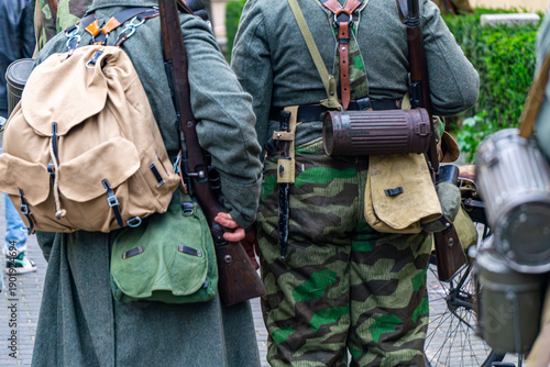 Фотография Wehrmacht infantry gear details, mountain rucksack and gas mask canister, German historical reenactment uniforms, WWII soldier equipment and splittertarn camouflage close-up