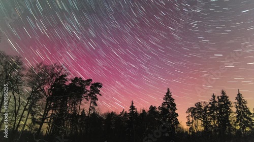 Northern lights and star trails on night sky timelapse video.