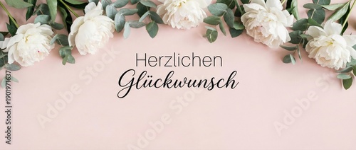 German congratulations text Herzlichen Glückwunsch with white peonies and eucalyptus on pink background Floral border flat lay for wedding or birthday greeting card Elegant calligraphy banner design