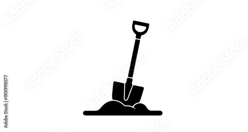 Shovel stuck in ground representing manual labor symbol in black and white
