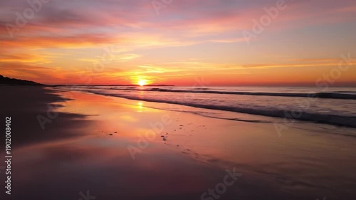 Wallpaper Mural Stunning sunset over the ocean with vibrant colors and reflections on the wet sand. Torontodigital.ca