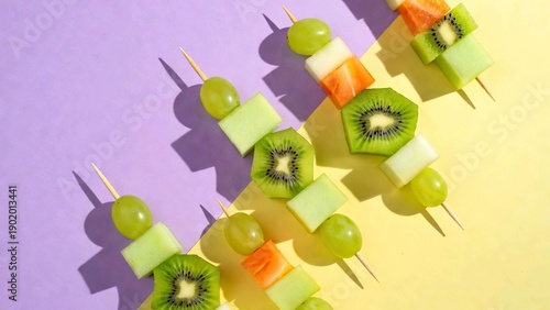 Fresh fruit skewers pattern with kiwi and grapes, healthy summer snack illustration on purple and yellow background, candid aesthetic food art
