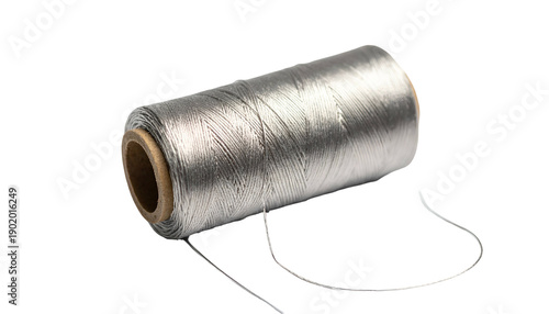 Close-up of a spool of silver-gray thread with some loose thread in front