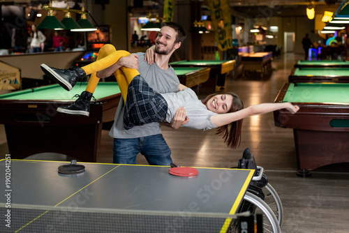 Woman with a disability and her boyfriend embracing enjoying playful moment