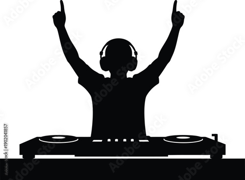 A DJ in silhouette celebrates with arms raised at a party