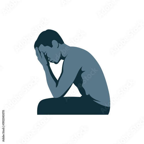 A man sits in a contemplative pose with his head in his hands