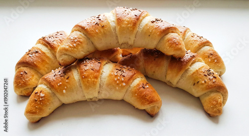 Freshly baked golden crescent rolls with salt and caraway seeds, bakery shop promotion or homemade breakfast menu