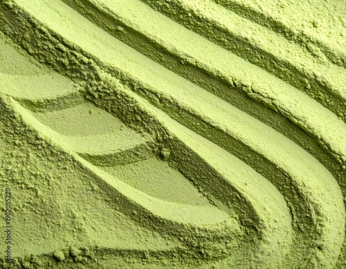 Textured close-up of light green powder with undulating patterns